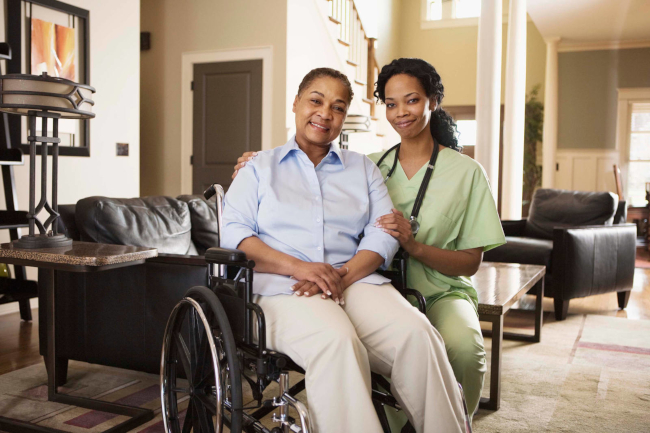 female caregiver wheelchair bound senior woman-650w